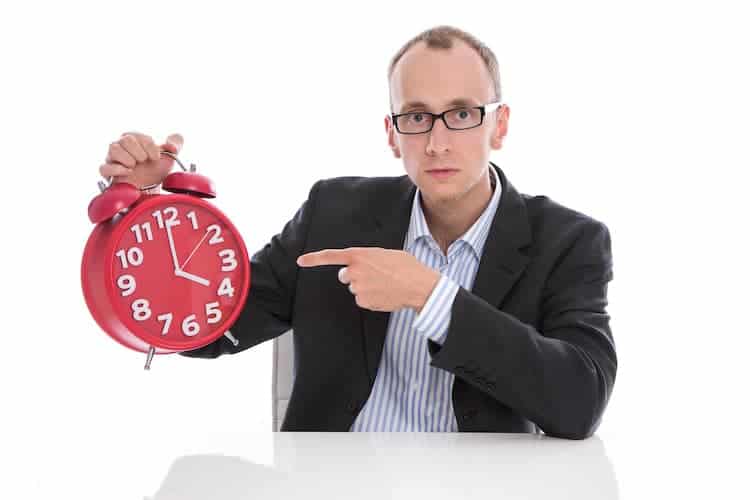 Man pointing at a clock