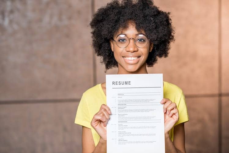 Woman holding an entry-level resume.